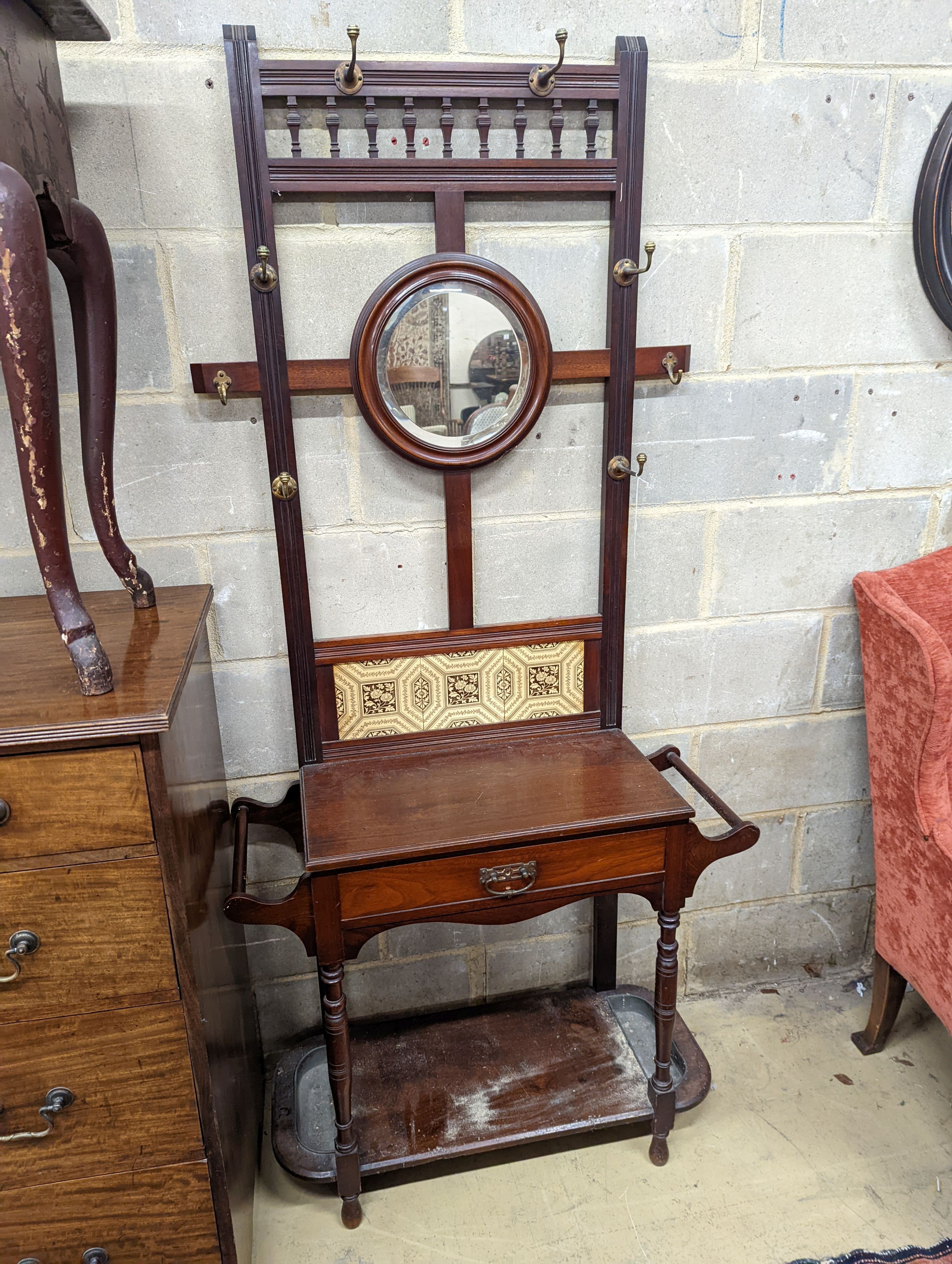 A late Victorian tile-backed mahogany wash stand, width 84cm, depth 34cm, height 184cm